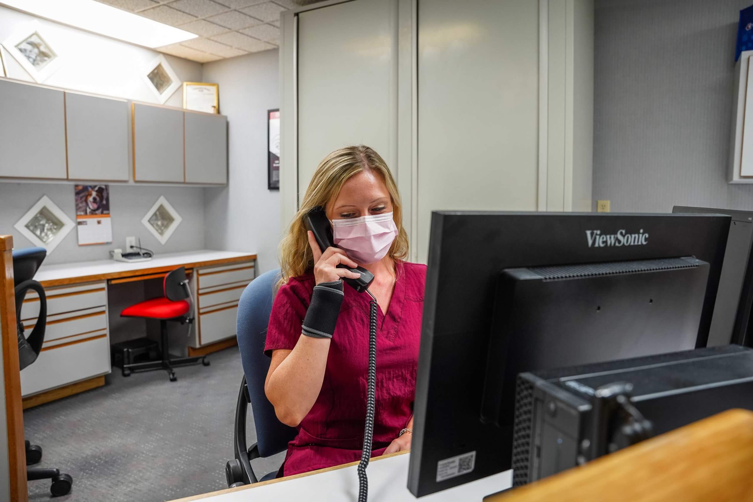 Receptionist on phone at Garrison Family Dentistry office
